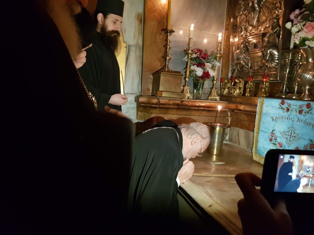 Patriarch Bartholomew venerating Jerusalem's Holy Sepulcher.
